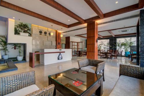 a living room with a glass table and chairs at Amritara Sadka Amritsar in Amritsar