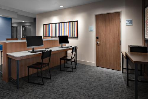 a lobby with a desk with two computers on it at Holiday Inn Express & Suites - Elkhorn - Lake Geneva Area, an IHG Hotel in Elkhorn