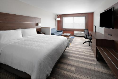 a hotel room with a bed and a desk at Holiday Inn Express & Suites - Elkhorn - Lake Geneva Area by IHG in Elkhorn