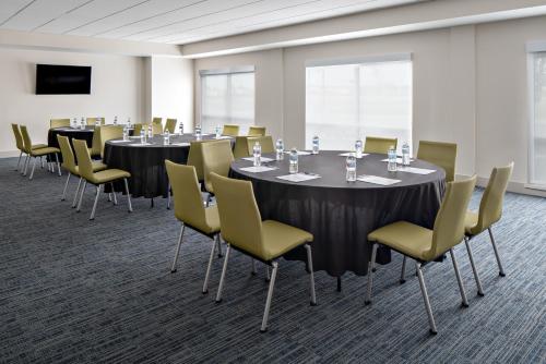 a conference room with round tables and chairs at Holiday Inn Express & Suites - Elkhorn - Lake Geneva Area by IHG in Elkhorn