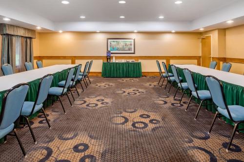 a conference room with tables and chairs and a podium at Holiday Inn Express Hotel & Suites Canton by IHG in Canton