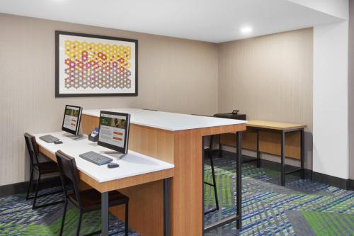 a room with two desks with two computers on them at Holiday Inn Express & Suites Culpeper by IHG in Culpeper