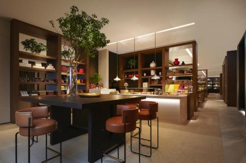 a kitchen with a large black island with bar stools at Park Hyatt Niseko Hanazono in Kutchan