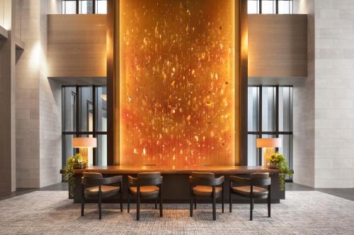 a lobby with a table and chairs in front of a wall at Park Hyatt Niseko Hanazono in Kutchan