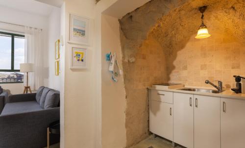 a kitchen with a couch and a sink in a room at Sapir Boutique Apartments in Beer Sheva