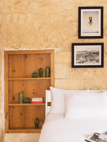 a bedroom with a bed and a wooden wall at Sapir Boutique Apartments in Beer Sheva