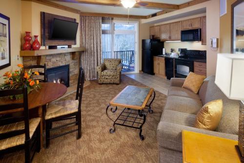 a living room with a couch and a table at Holiday Inn Club Vacations Smoky Mountain Resort in Gatlinburg