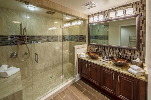 a bathroom with two sinks and a shower at Holiday Inn Club Vacations Smoky Mountain Resort, an IHG Hotel in Gatlinburg