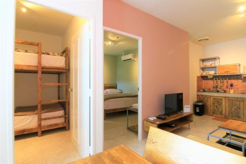 a room with two bunk beds and a television at Queen Victoria Apartment Batam in Batam Center
