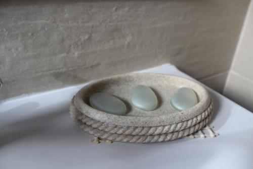 a stone bowl sitting on top of a toilet at Fodor Ház in Miercurea-Ciuc