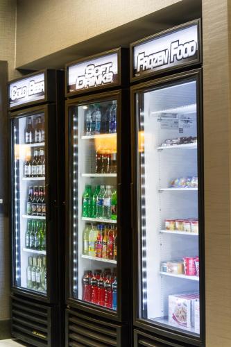 two refrigerators with drinks in them in a store at Holiday Inn Express and Suites Madison Central by IHG in Madison