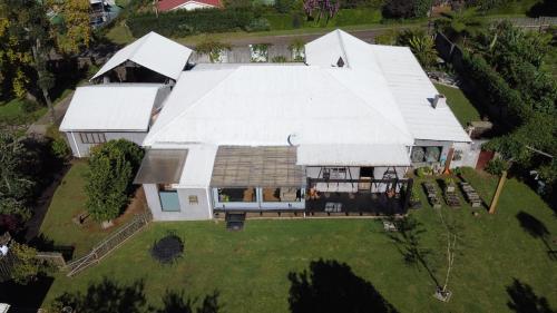 an aerial view of a house with a large white roof at Laguna Lodge in Graskop