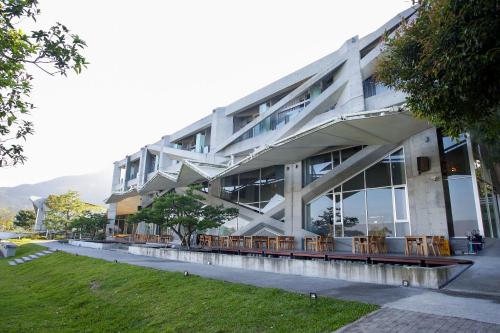 a building with tables and chairs in front of it at Khokak Panoramas Hotel in Gukeng