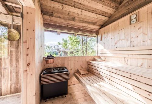 an interior of a wooden sauna with a stove at Hotel Tann in Collalbo