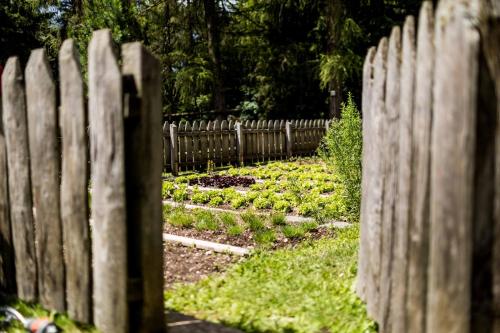 a wooden fence in front of a garden at Hotel Tann in Collalbo