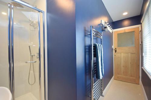 a bathroom with a shower with a glass door at Seagull Cottage, Aldwick in Bognor Regis