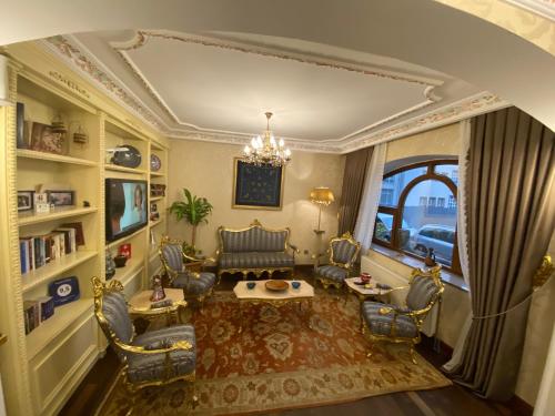 a living room with chairs and a chandelier at Muyan Suites in Istanbul