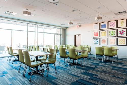a conference room with tables and chairs and windows at Holiday Inn Express & Suites Madison by IHG in Madison