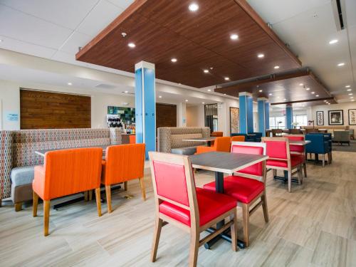 a restaurant with colorful chairs and a table at Holiday Inn Express & Suites - Southaven Central - Memphis, an IHG Hotel in Southaven