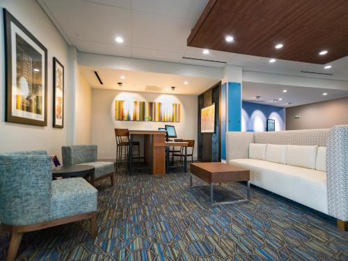 a lobby with a couch and chairs and a table at Holiday Inn Express & Suites - Southaven Central - Memphis by IHG in Southaven