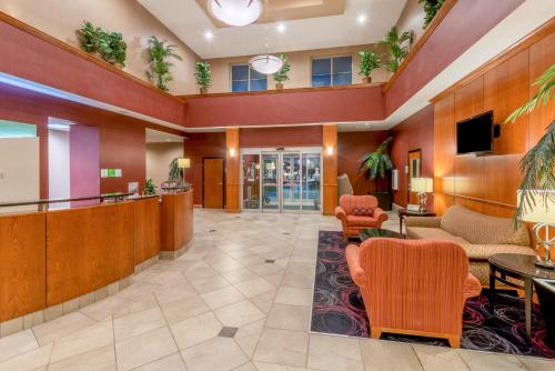 a lobby of a hospital with chairs and tables at Holiday Inn Hotel & Suites Grand Junction-Airport by IHG in Grand Junction