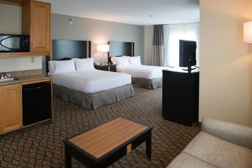a hotel room with two beds and a television at Holiday Inn Express Hotel & Suites Chanhassen by IHG in Chanhassen