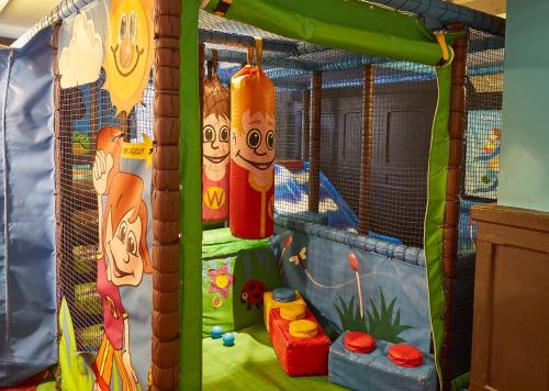a childrens indoor play area with a large inflatable cage at Darrington by Greene King Inns in Darrington