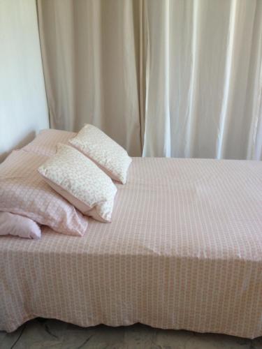 a bed with two pillows on top of it at Appartement vue mer in Six-Fours-les-Plages