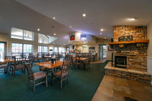 a restaurant with tables and chairs and a fireplace at Holiday Inn Club Vacations Holiday Hills Resort at Branson an IHG Hotel in Branson