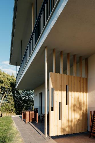 a wooden door in front of a building with a staircase at Apartamentos Ribeira Sacra in Parada del Sil