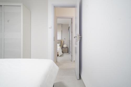 a bedroom with white walls and a white bed at Presiada heart of Akko in ‘Akko