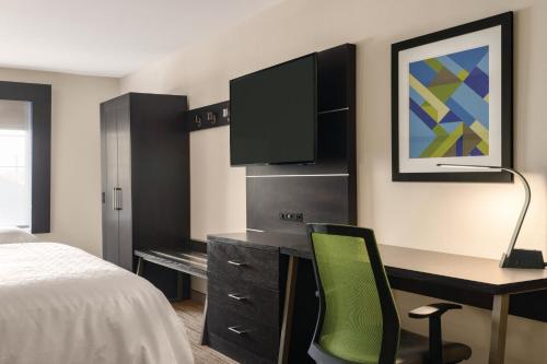 a hotel room with a desk and a tv at Holiday Inn Express Hotel & Suites Lawton-Fort Sill by IHG in Lawton