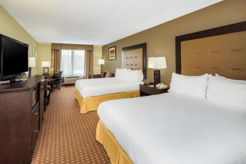 a hotel room with two beds and a flat screen tv at Holiday Inn Express Hotel & Suites-North East by IHG in North East