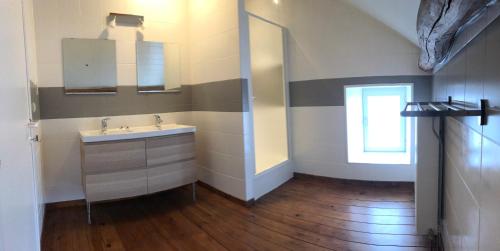 a bathroom with a sink and a mirror at Maison Flo in Houffalize
