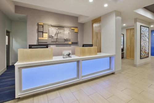 an office lobby with a reception desk and chairs at Holiday Inn Express Niles by IHG in Niles