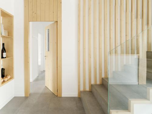 a staircase in a house with a glass railing at Apartamentos Ribeira Sacra in Parada del Sil