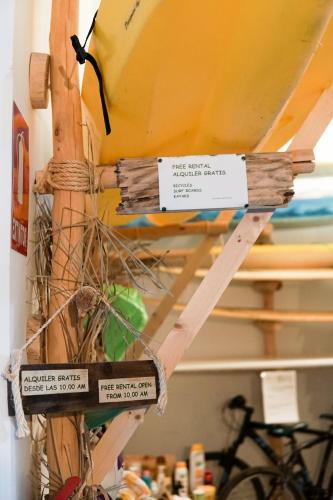 a yellow surfboard on a shelf with signs on it at Cactus Host in Las Palmas de Gran Canaria