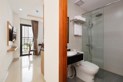 a bathroom with a toilet and a sink and a shower at XO Hotel & Apartments in Nha Trang