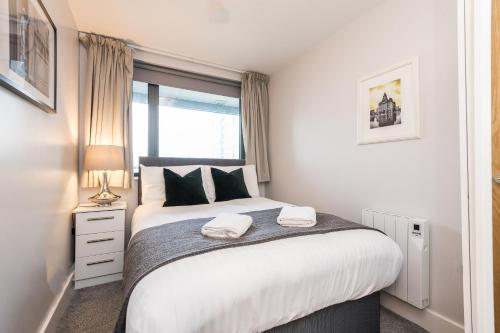 a bedroom with a large bed with a window at Host & Stay - Standish Street Place in Liverpool