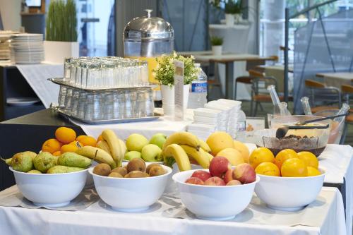 a bunch of bowls of fruit on a table at Club Vacances Bleues Les Jardins De l'Atlantique in Talmont