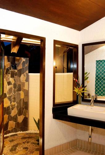 a bathroom with a sink and a mirror at Peace Laguna Resort & Spa in Ao Nang Beach