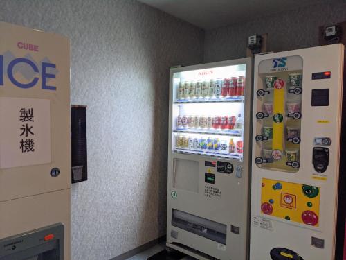 a vending machine with drinks in it in a room at Toyama Jiyukan in Toyama