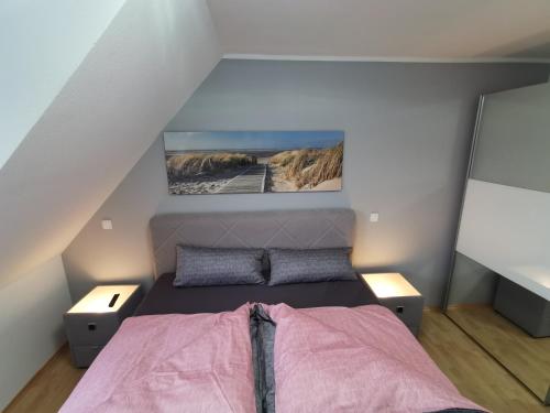 a small bedroom with a bed in a attic at Luxuriöses Wellnes Apartment in Bad Essen