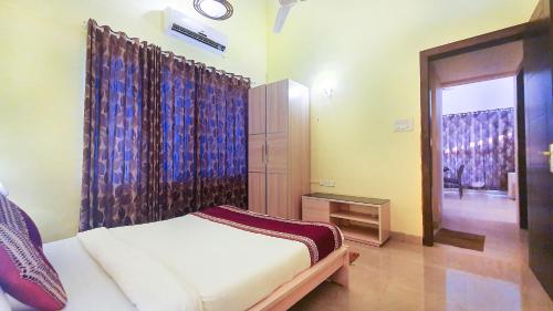 a small bedroom with a bed and a window at Rainforest Resort and Spa, Igatpuri -Nature's Luxury Awaits in Igatpuri