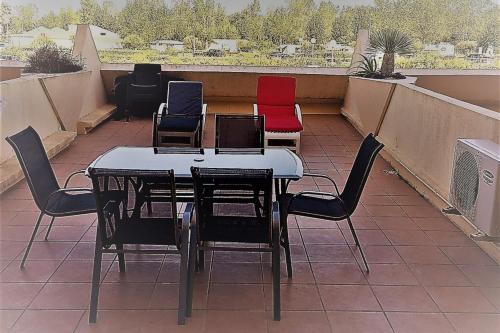 a table and chairs sitting on a roof at Cap d'Agde Naturist Héliopolis K 106 in Cap d'Agde