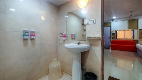 a bathroom with a white sink and a shower at Rainforest Resort and Spa, Igatpuri -Nature's Luxury Awaits in Igatpuri
