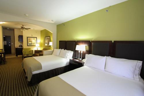 a hotel room with two beds and a desk at Holiday Inn Express Hotel & Suites Nacogdoches by IHG in Nacogdoches