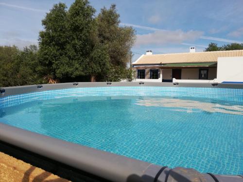 a large swimming pool in front of a house at Casa da Pedra Azul in Santo Estêvão