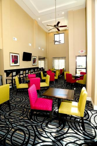 a waiting room with colorful chairs and tables at Holiday Inn Express & Suites Marion Northeast by IHG in Marion