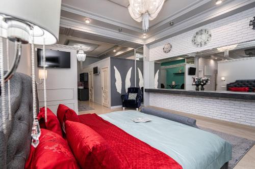 a bedroom with a large bed with red pillows at Krepost Mini Hotel in Makhachkala